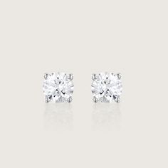 Our Martina earrings are a pair of glamorous 1.04ct diamond earrings. There's nothing more classic to wear than our Martina diamond earrings. They are iconic, classic and beautiful. With their perfect cut and impeccable shape, they are every woman's must-haves. A 5mm White diamond held by 4 white gold prongs and closes with a butterfly back. The earrings are sold as singles The Martina can be worn to top off an exquisite evening look. They are both classic and stunning, and add the perfect sparkle for a polished, feminine style. They can be customized with any stones of your choice. All features can be customized! please contact us if you wish to make changes, we love making custom designs. All of our jewelry is carefully handmade in our atelier *HC diamond are all conflict-free diamonds T Timeless Platinum Earrings, Classic White Solitaire Diamond Earrings, Refined Diamond Earrings For Formal Occasions, Luxury White Gold Earrings With Single Diamond, Refined Diamond Earrings With Diamond Accents, Classic Brilliant Cut Diamond White Earrings, Classic Solitaire Cubic Zirconia Earrings, Classic Diamond Solitaire Earrings, Timeless Diamond Cut Earrings For Formal Occasions