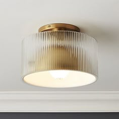 a close up of a light fixture on a ceiling in a room with white walls