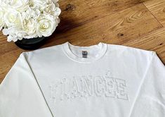 Did you know that Fiancee is for the woman, and Fiance is for the man?? This embroidered sweatshirt is a beautiful touch to a beautiful chapter in your life! This white on white fiance sweatshirt is beautifully embroidered and stitched onto a soft, comfy sweatshirt! The perfect gift, whether you're the bride, or you're looking for an engagement gift for a bride to be! Order this embroidered fiance sweatshirt today! And don't forget up your man! Head over to our shop for our men's version! Fiance Sweatshirt, White On White, Bridal Shower Gift, Comfy Sweatshirt, Embroidered Sweatshirt, Bride To Be, Embroidered Sweatshirts, Bridal Shower Gifts, Your Man