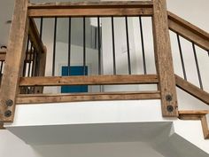 a wooden stair case with metal railings