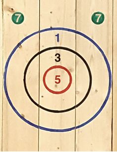 an image of a target with the number five on it in front of a wooden fence