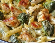 pasta with chicken, broccoli and sauce in a bowl