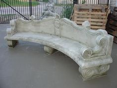 a white bench sitting on top of a cement slab