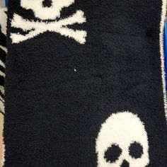 a black and white rug with skulls on it