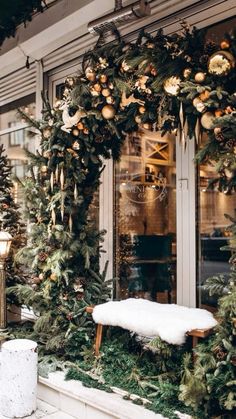 christmas wreaths and decorations on display in front of a store