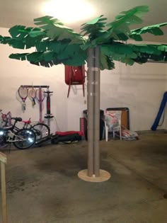 there is a palm tree in the middle of a garage with several bicycles on it