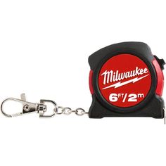 a red and black measuring tape keychain with the word milwaukee printed on it