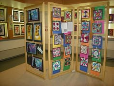 a room divider made out of wood and decorated with colorful quilts on it