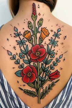 the back of a woman's neck with flowers and stars on it, all around her