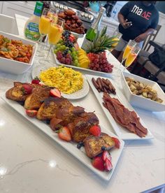 an assortment of food is displayed on the counter