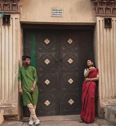 two people standing in front of a door