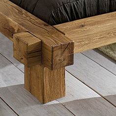 a wooden bench sitting on top of a hard wood floor