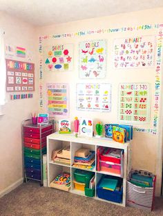 a child's playroom with lots of toys on the wall and colorful bins