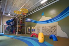 an indoor play area with slides and climbing equipment