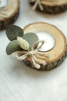 some wood slices with leaves and a candle