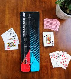 playing cards, dices and poker chips on a wooden table next to a potted plant