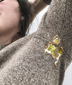 a close up of a person wearing a sweater