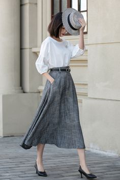 Elegant Flow - The Charcoal Pleated Skirt 4899 Elegant Long Gray Skirt, Chic Long Gray Skirt, Elegant Gray Lined Skirt, Elegant Gray Pleated Skirt, Gray Flowy Flared Skirt, Gray Flared Flowy Skirt, Elegant Gray Lined Skirt Bottoms, Classic Pleated Gray Skirt, Gray Formal Skirt For Spring