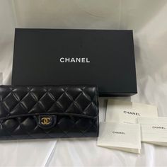 Chanel Quilted Classic Long Flap Long Wallet Black Leather Gold Coco Mark Boxed Used, In Excellent Condition Minor Scuffs On Corners Visible Scratches On Hardware Material Holds Original Shape Measurement: 7.75"L X 4"H X 1.4"W Polished Gold Hardware With Little Bit Of Fading Classic Flap With Snap Button Closure Black Quilted Lambskin Leather Maroon Fabric And Lambskin Leather Interior Lining Twelve Card Slots Two Open Compartments, Two Lining Compartments Zipper Coin Pocket Include Coa From Rea Designer Clutch With Original Box For Formal Occasions, Classic Wallet On Chain As Gift, Luxury Evening Clutch With Original Box, Classic Clutch For Formal Occasions, Elegant Black Formal Wallets, Designer Bifold Clutch For Evening, Luxury Clutch Wallet For Formal Occasions, Luxury Formal Clutch Wallet, Elegant Wallet On Chain For Gift