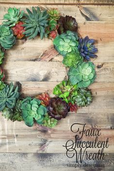 a wreath made out of succulents sitting on top of a wooden table