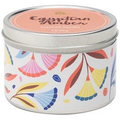 an empty tin candle with colorful designs on the lid and bottom, sitting in front of a white background