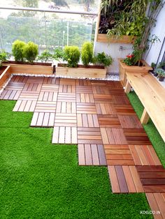 an outdoor area with grass and wooden benches