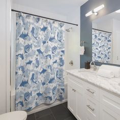 a blue and white shower curtain in a bathroom