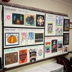 a bulletin board with many pictures on it in an office building or school classroom area