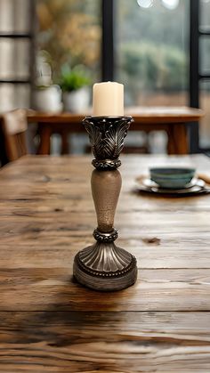 a candle sits on top of a wooden table