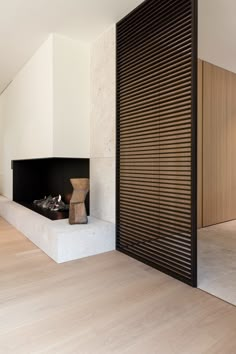 an empty room with a fireplace and wooden slats