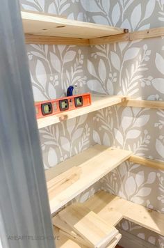 the shelves are made out of plywood and have some tape measures on them