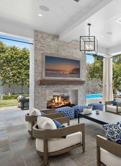 a living room filled with furniture and a fire place in front of a tv mounted on the wall