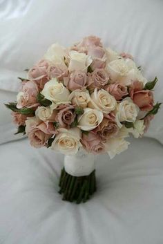 a bridal bouquet sitting on top of a white chair