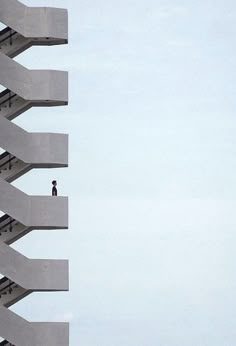 a person standing on top of a tall building