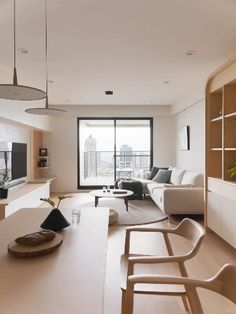 a living room filled with furniture and a flat screen tv on top of a wooden shelf