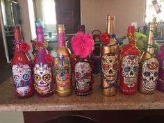 there are many bottles decorated with sugar skulls