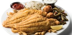 a white plate topped with fried fish and french fries