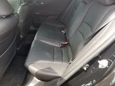 the interior of a car with black leather seats