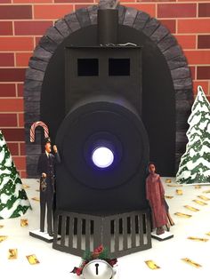 a paper model of a man and woman standing in front of a fake train engine