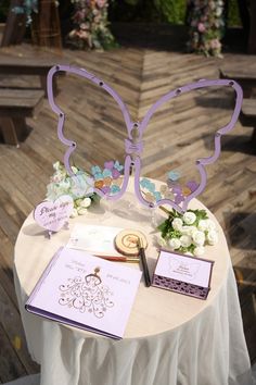 a table topped with a purple butterfly decoration