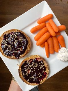 there are carrots and blueberry pies on the plate