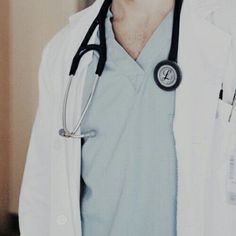 a man wearing a white coat with a stethoscope on his neck