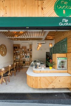 the inside of a restaurant with wooden tables and chairs around it's counter area