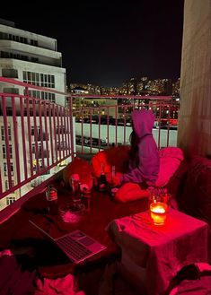 a person sitting at a table on top of a roof