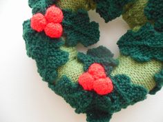 a green and red knitted christmas wreath