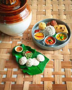 a plate with some food on top of it next to a potted plant and bowl