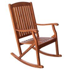 a wooden rocking chair with slatted back and arm rests on an isolated white background