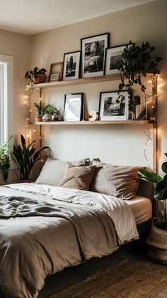 a bed sitting in a bedroom next to a window with pictures on the wall above it