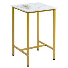 a white and yellow table with a cup on it