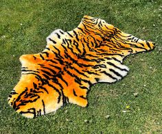 a tiger print rug is laying on the grass